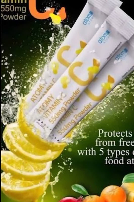 Vitamin C powder packets with lemon slices and fruits on a green background