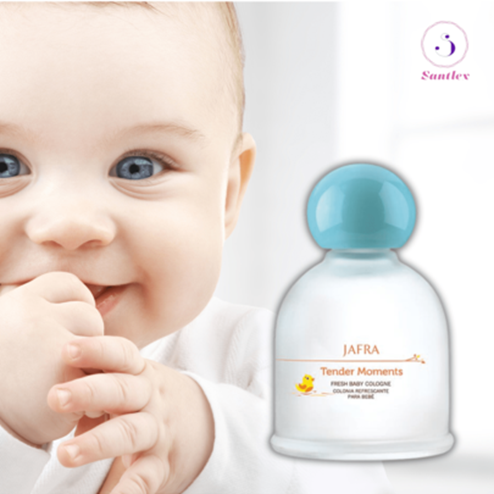 Baby with blue eyes and a Santley baby bottle on a white background