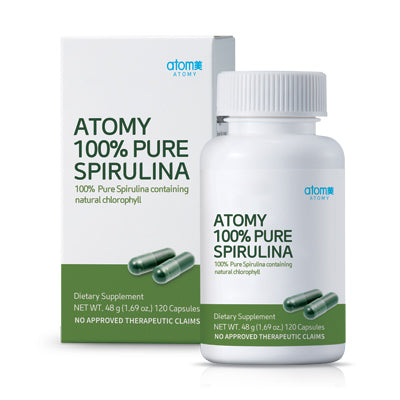A bottle of Atomy 100% Pure Spirulina, with a label showing the brand name, product description, and an image of a spirulina capsule. The background is white with a green and white spirulina plant illustration.